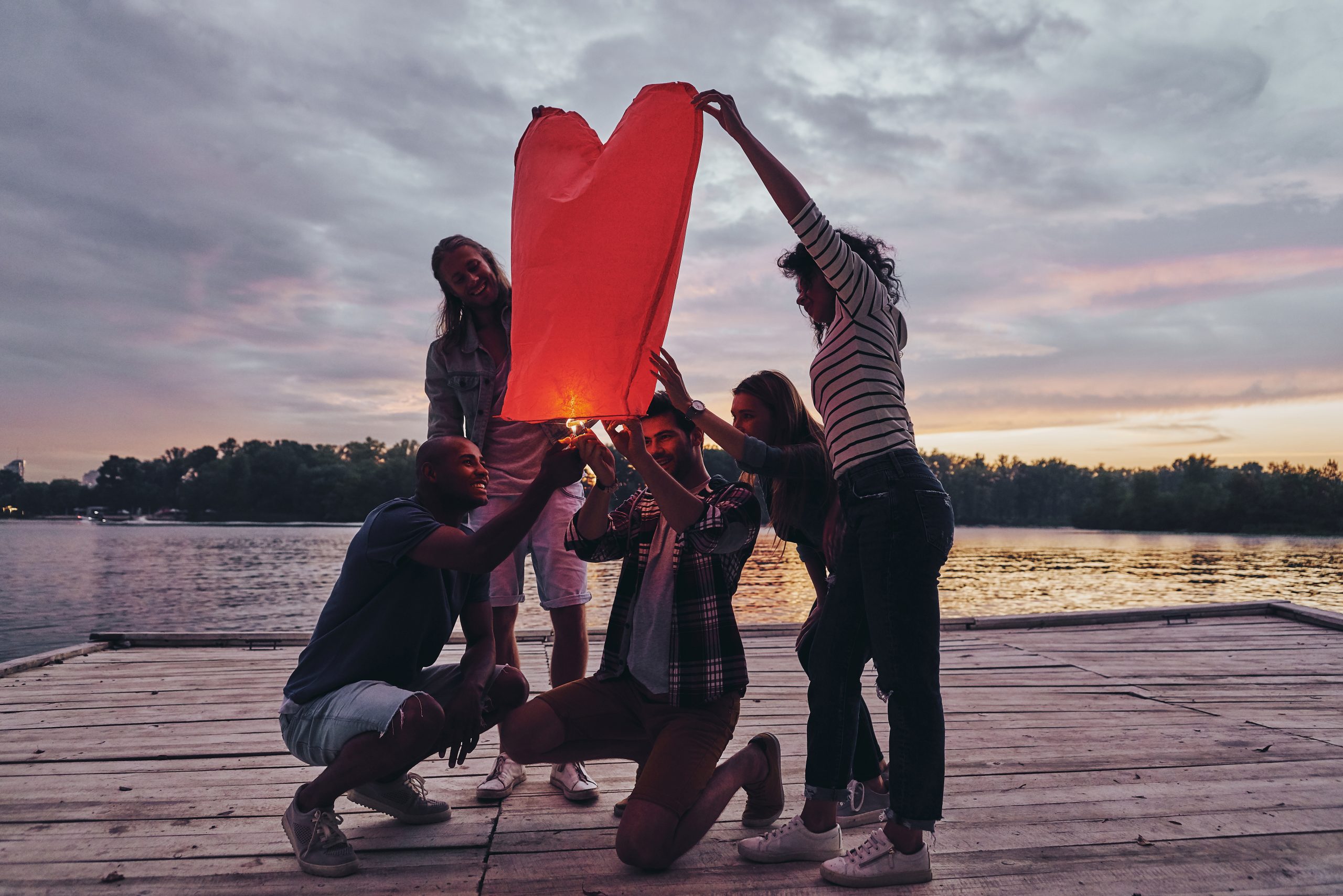 people holding a Heart shaped lantern representing building love 