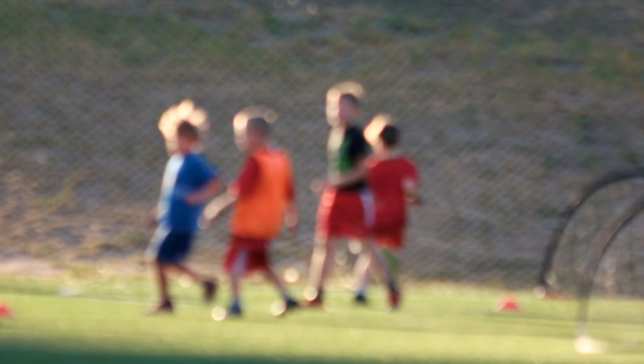 blurry picture of four children in a field